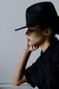 Side View Shot of a Sad Woman in Black Hat Looking Down