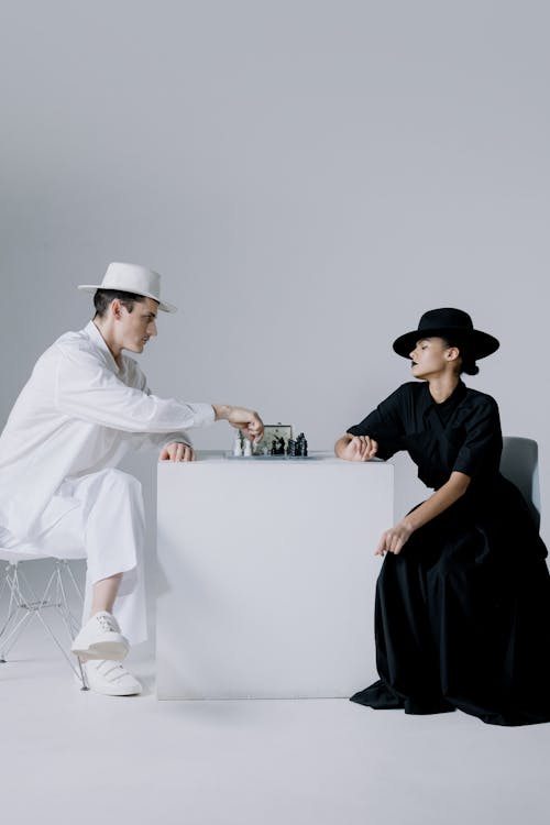 Stylish Man and Woman Playing Chess