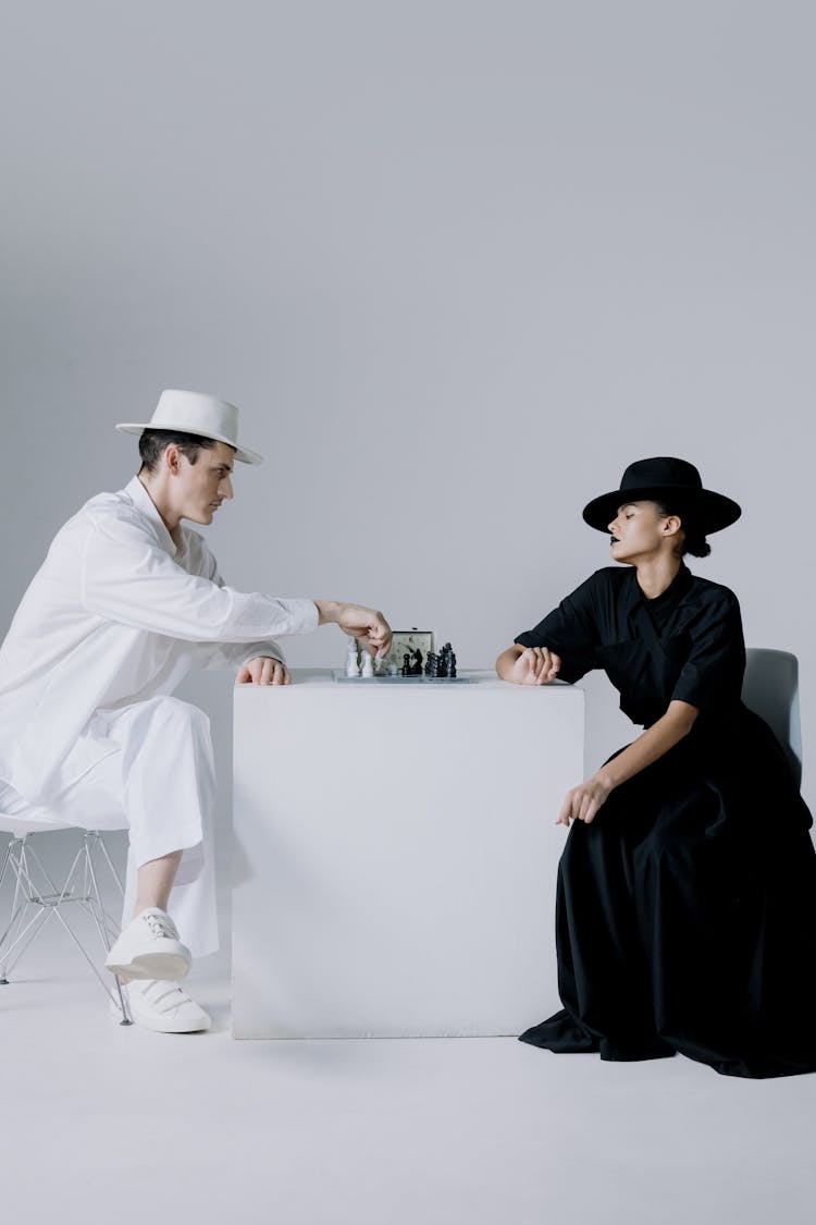 Stylish Man And Woman Playing Chess