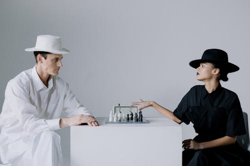 Free Man and Woman Playing Chess Stock Photo