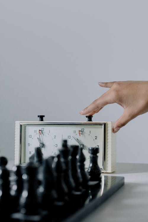 Free Person Pressing a Chess Clock Stock Photo