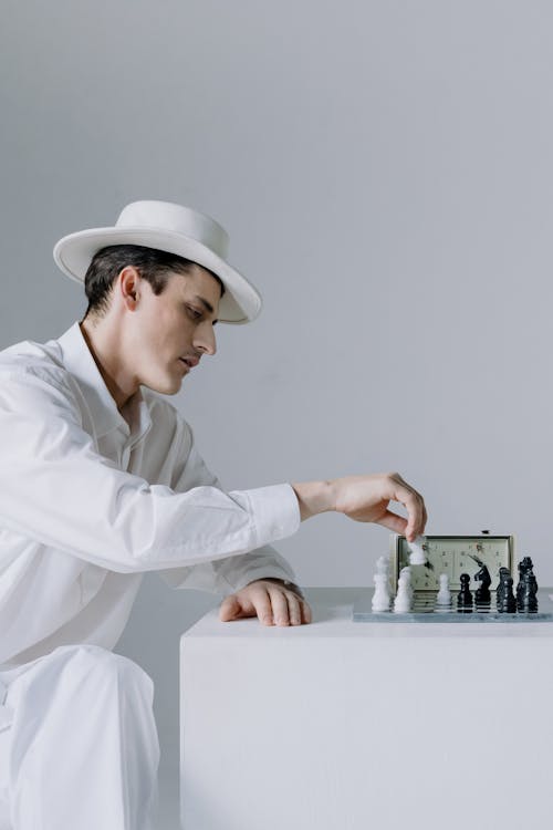 Man in Clothing Playing Chess