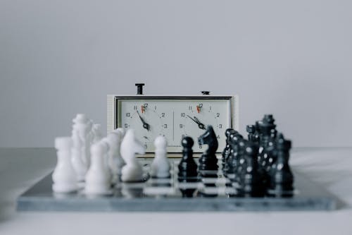 Chess Clock Behind Chess Pieces
