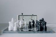 Chess Clock Behind Chess Pieces
