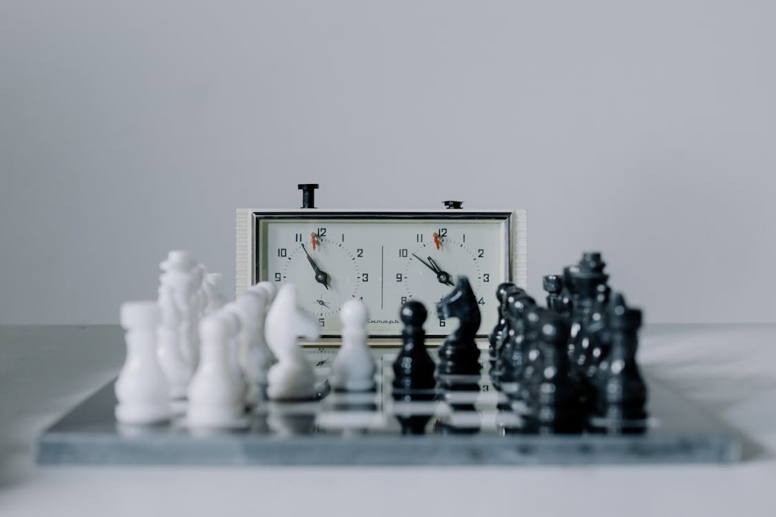 Chess Clock Behind Chess Pieces