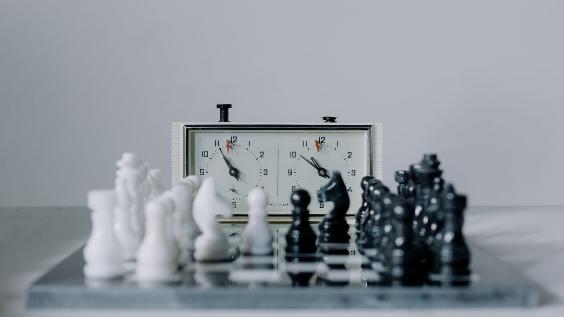 Modafinil for Chess Players: Enhancing Focus and Performance Close-up view of a chess match featuring black and white pieces and a chess clock — modafinil for chess players