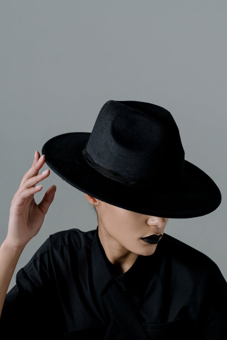 Person With Black Lipstick Wearing Black Hat