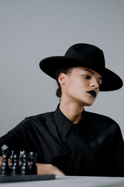 Woman Wearing a Black Top and Hat
