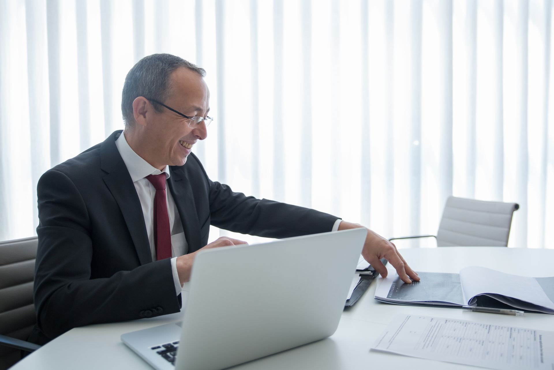 A Smiling Businessman Looking at Documents