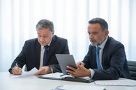 Man in Black Suit Jacket Using Macbook