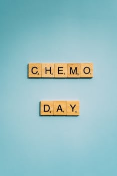 Scrabble tiles spell 'Chemo Day' on a light blue background, symbolizing cancer awareness and support.