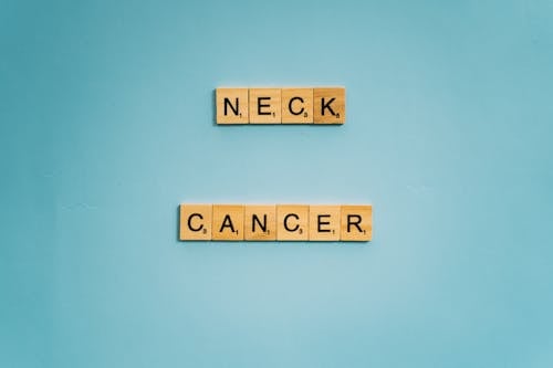 Free Neck and Cancer Words Spelled on Wooden Scrabble Tiles Stock Photo