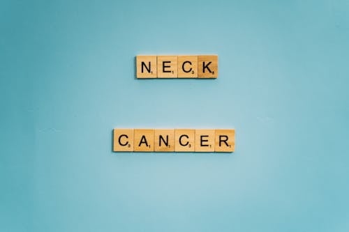 Free Neck and Cancer Words Spelled on Wooden Scrabble Tiles Stock Photo