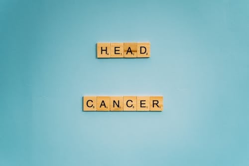 Free Head and Cancer Words Spelled on Wooden Scrabble Tiles Stock Photo