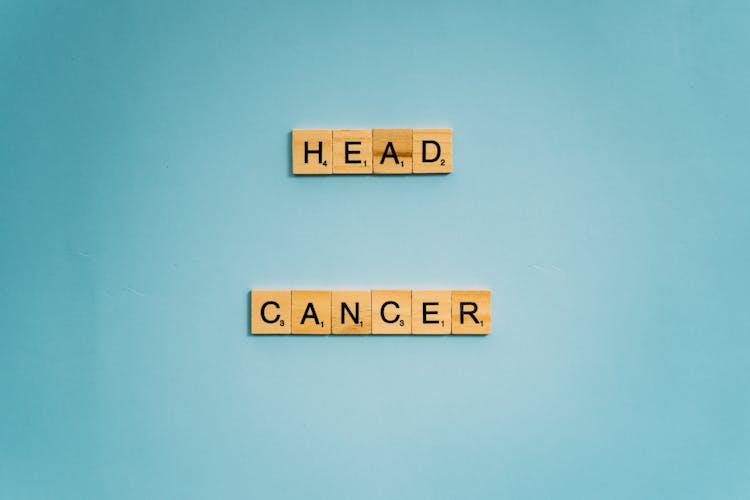 Head And Cancer Words Spelled On Wooden Scrabble Tiles