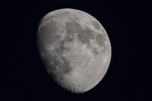 Free Stunning close-up photograph capturing the moon's surface details in the night sky. Stock Photo