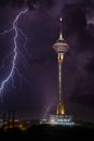 Lighted Tower With Fireworks Display during Night Time