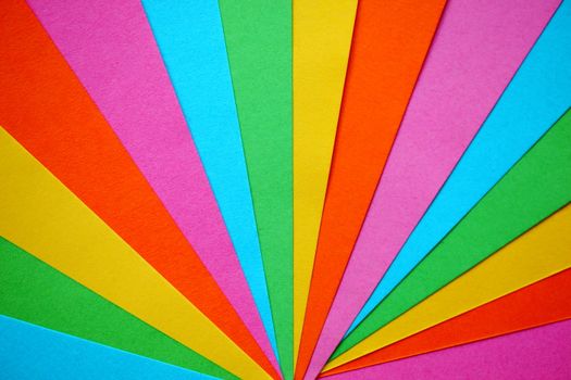 A vivid display of rainbow-colored paper arranged in a fan-like pattern, perfect for background or wallpaper.