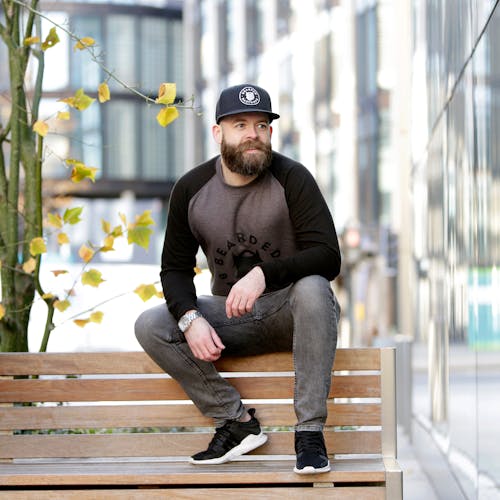 Free stock photo of bearded man, park bench, wooden bench