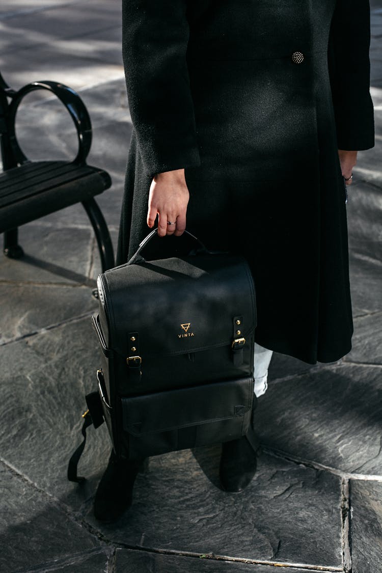 Person Holding Black Leather Backpack