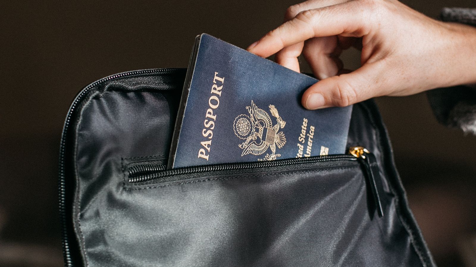 Passport and travel documents beside a notebook for choosing a TEFL destination