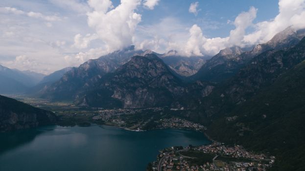 Stunning aerial view capturing a serene lake surrounded by mountains and a small town.