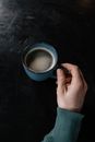 Person Holding Blue Ceramic Mug With Black Liquid