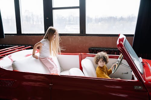 Free Kids Sitting in Car in Photo Studio Stock Photo