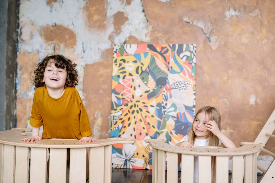 Photo by Yan Krukau on Pexels Two joyful children playing indoors against a colorful abstract wall background. - Photo by Yan Krukau on Pexels