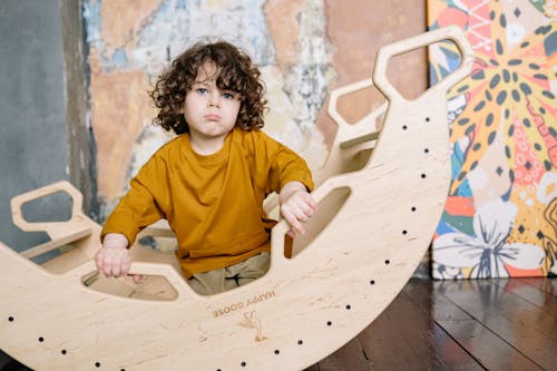 Young Boy Sitting on a Seesaw