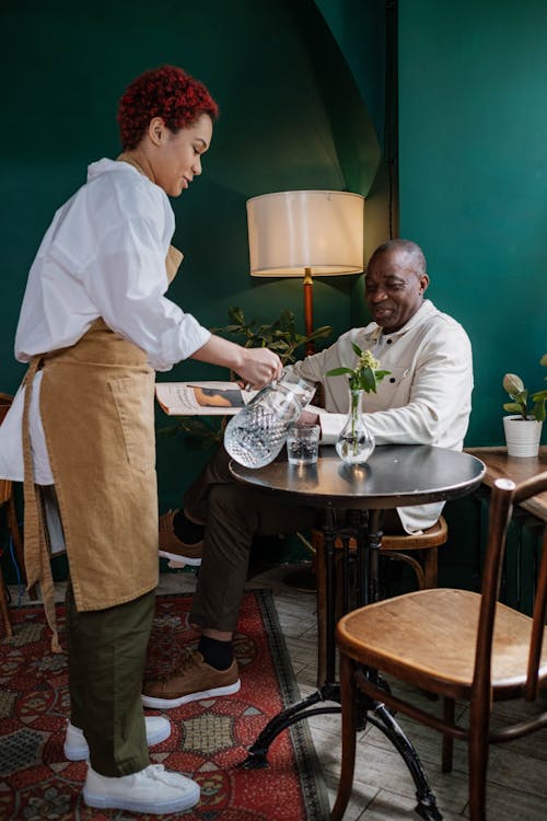 Free A Waitress Serving Water  Stock Photo