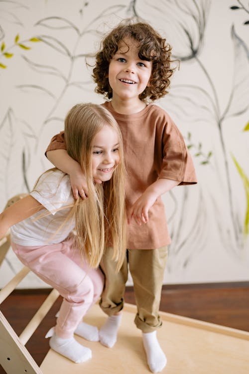 A Young Boy and Young Girl Embracing Together