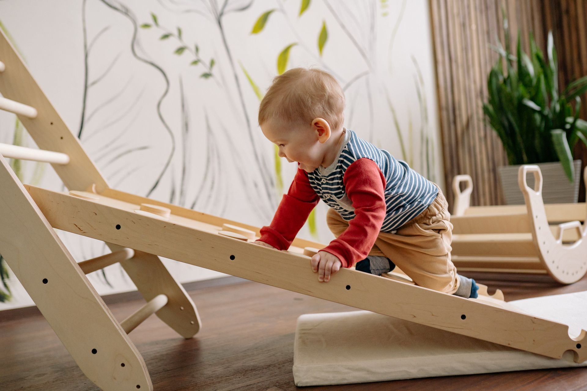 Happy Toddler Climbing Up a Wooden Ladder