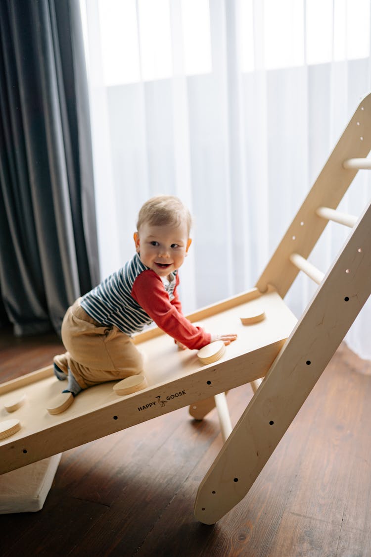 A Toddler On A Climbing Ramp