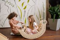 Kids Playing with a Wooden Rocker