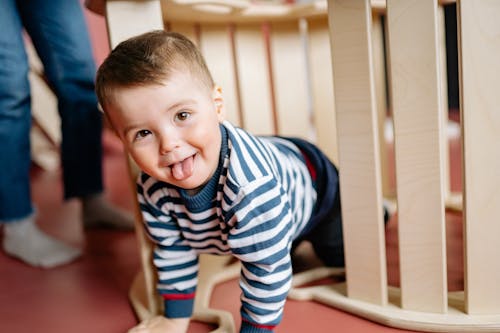 Little Boy Playing Under a Seesaw