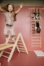 Woman in White Shirt and White Pants Climbing on Ladder