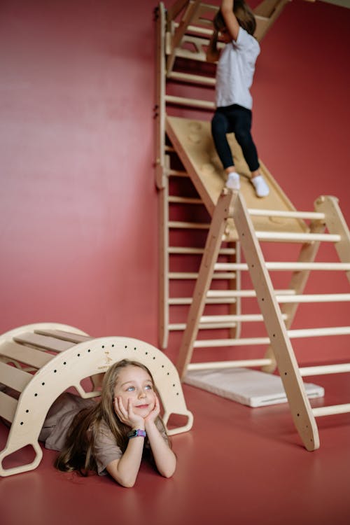 Child Playing on a Wooden Ladder