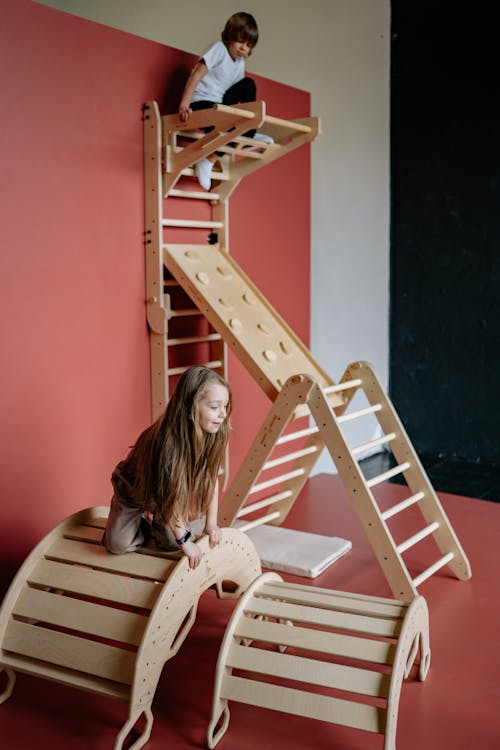 A Young Boy Climbing on Wooden Ladder