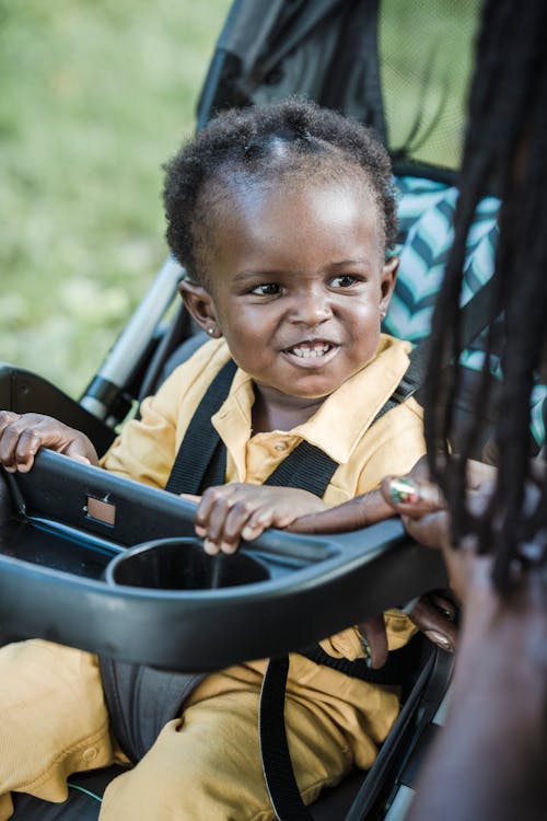 Child Sitting on a Stroller