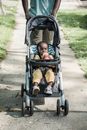 A Baby in Stroller on the Street
