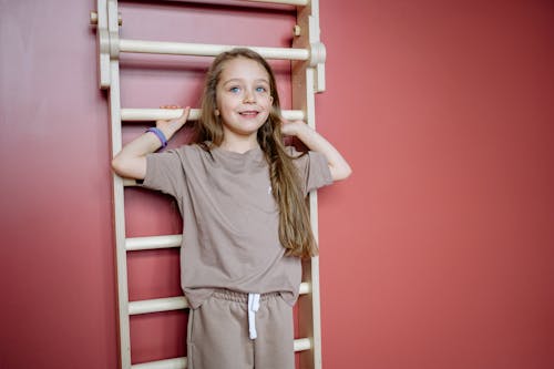 Free Kid Standing Beside a Pink Wall Stock Photo