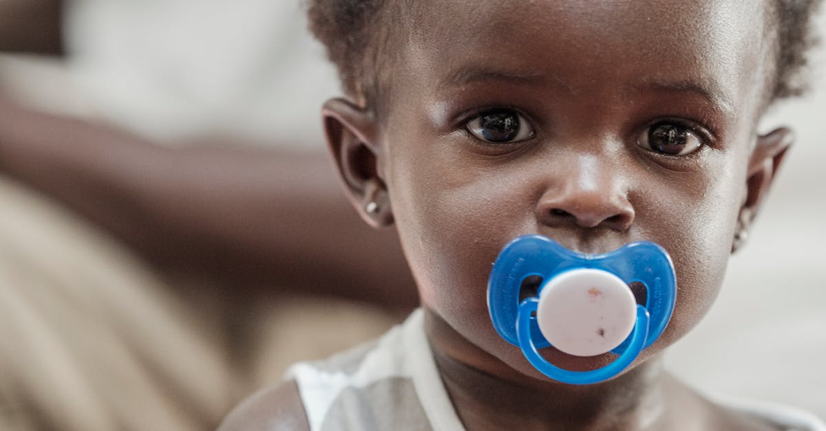Close Up Photo of a Little Girl with a Pacifier · Free Stock Photo