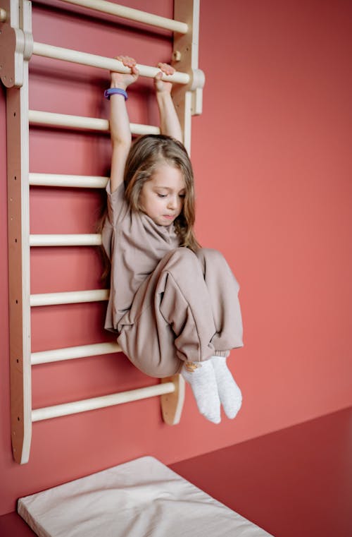 Little Girl hanging on a Ladder