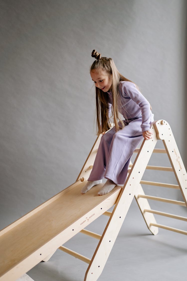 A Young Girl Playing On The Slide