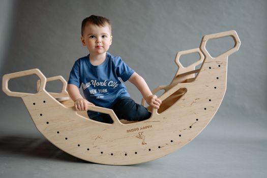 Boy in Blue and White Crew Neck T-shirt Sitting on White Wooden Chair
