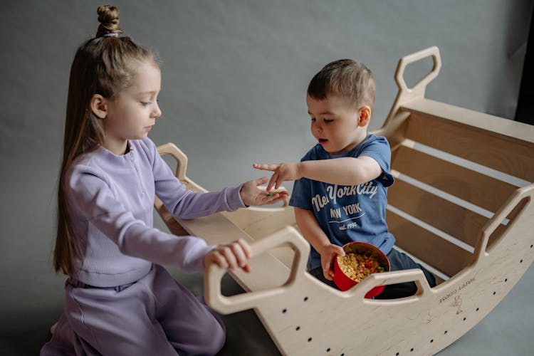 Children Playing On A Seesaw