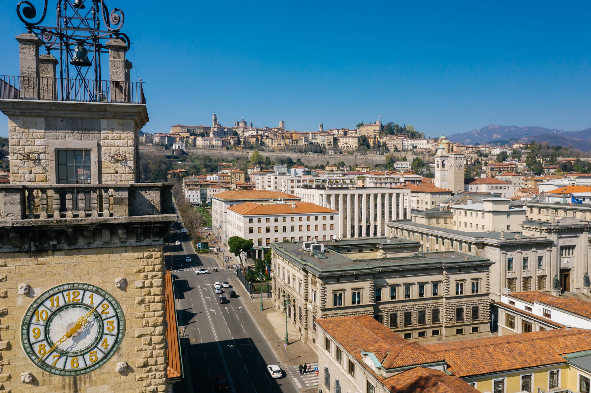 Aerial view of Bergamo with iconic clock tower and historic architecture on a sunny day.