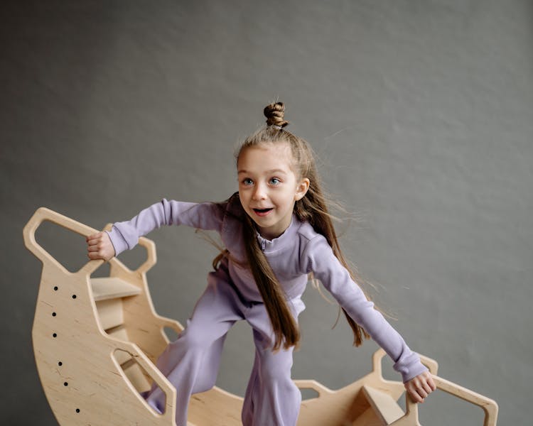 Cute Little Girl In A Wooden Rocking Boat