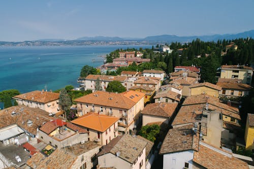 Houses With Roof Tiles Near a Blue Sea